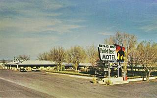 1960s motel with trees around it and neon sign