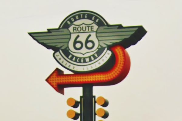 neo-vintage sign with a US 66 shield and yellow arrow curving the Route 66 Raceway