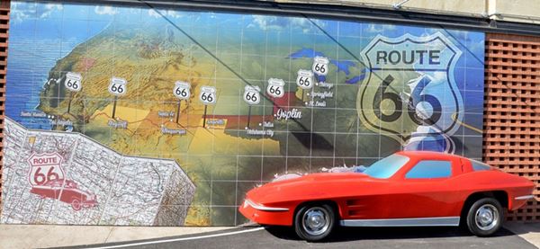 Mural with Route 66 shield, map and a 3-D car