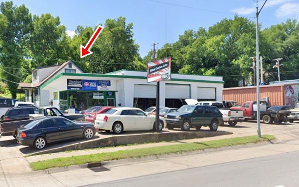 vintage gas station on corner, trees, cars and garage